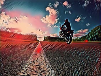 Blurred motion of man riding motorcycle against sky