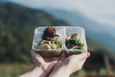 Midsection of person holding food