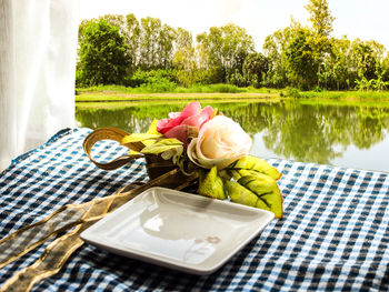 View of ice cream on table by lake