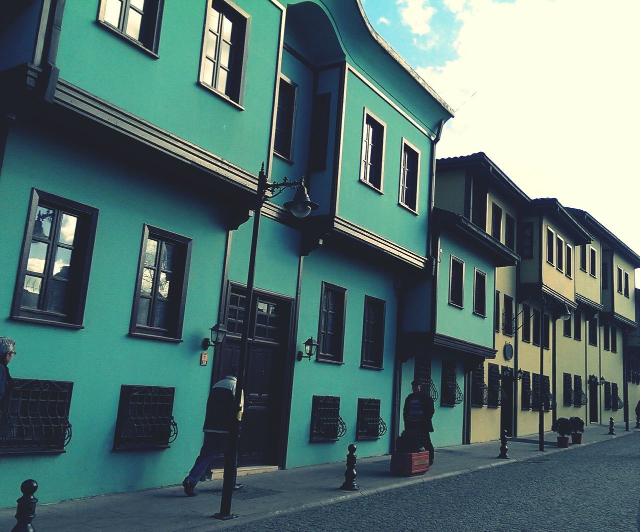 building exterior, architecture, built structure, window, residential building, residential structure, building, low angle view, sky, city, balcony, house, street, day, facade, outdoors, sunlight, street light, apartment, no people