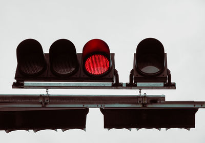 Low angle view of road signal against clear sky