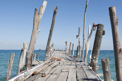 Wooden pier leading to sea