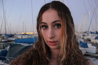 Portrait of beautiful young woman against sky