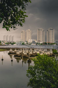 Scenic view of lake by buildings against sky