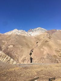 Scenic view of mountains against clear blue sky