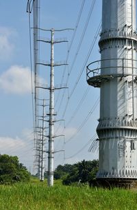 Low angle view of electricity pylon against sky