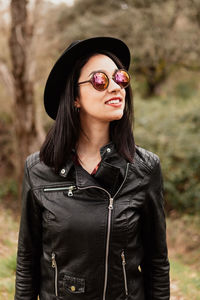 Young woman wearing hat standing outdoors