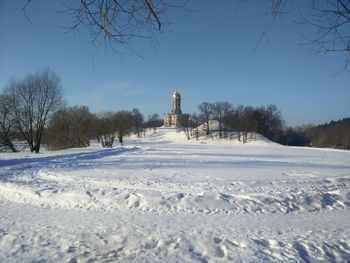 Snow covered field against sky