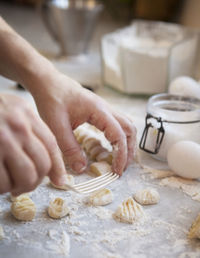 Gnocchi being pressed with fork