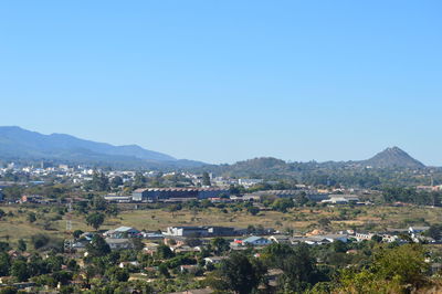 Townscape against clear blue sky