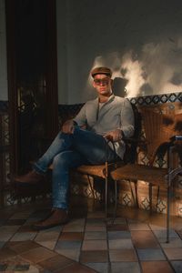 Portrait of man sitting on chair at home