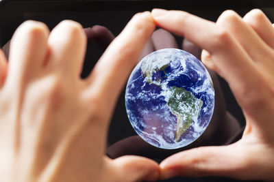 Close-up of person holding crystal ball