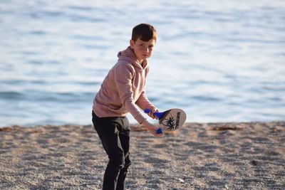 Full length of boy playing on beach