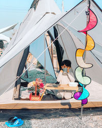 People sitting on sailboat against sky