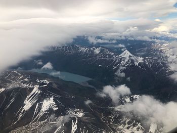 Aerial view of snowcapped mountains against sky