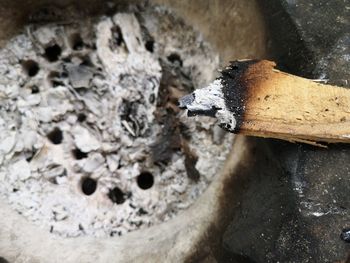 High angle view of cigarette smoking on wood