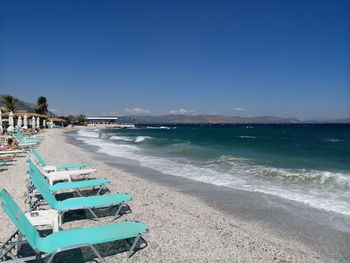 Scenic view of beach against blue sky