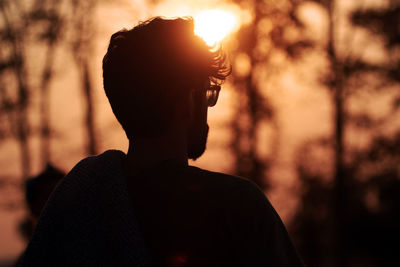 Close-up portrait of silhouette man standing against sky during sunset