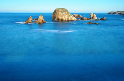 Scenic view of sea against blue sky