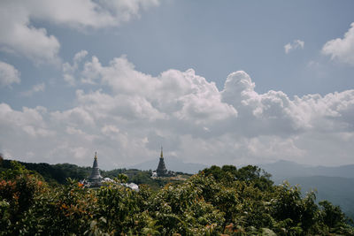 Panoramic view of trees and buildings against sky