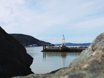 Scenic shot of calm sea with mountain range in background