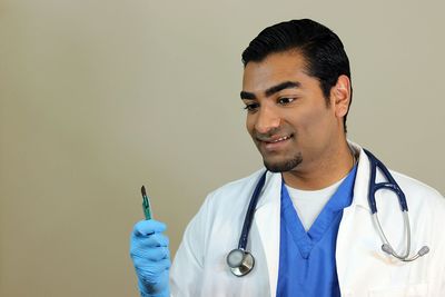 Close-up of smiling man against gray background