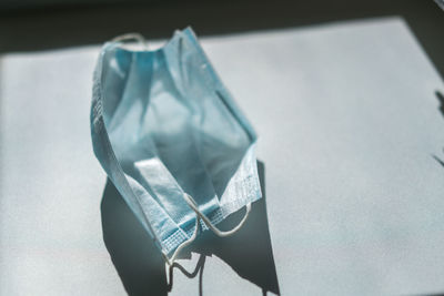 High angle view of medical mask on table 