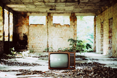 Old television set in abandoned house