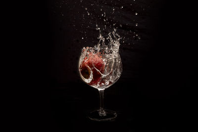 Water drops on glass against black background