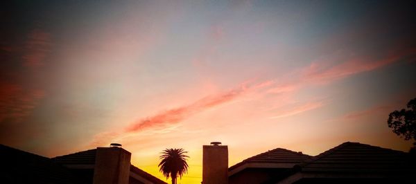 Low angle view of silhouette buildings against sky during sunset