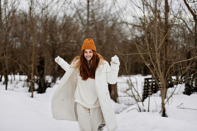 Happy woman enjoying outdoors during winter