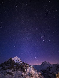 Scenic view of mountains against sky at night