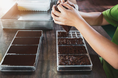 High angle view of woman preparing food on table