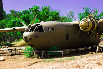 Abandoned vehicle on land against sky