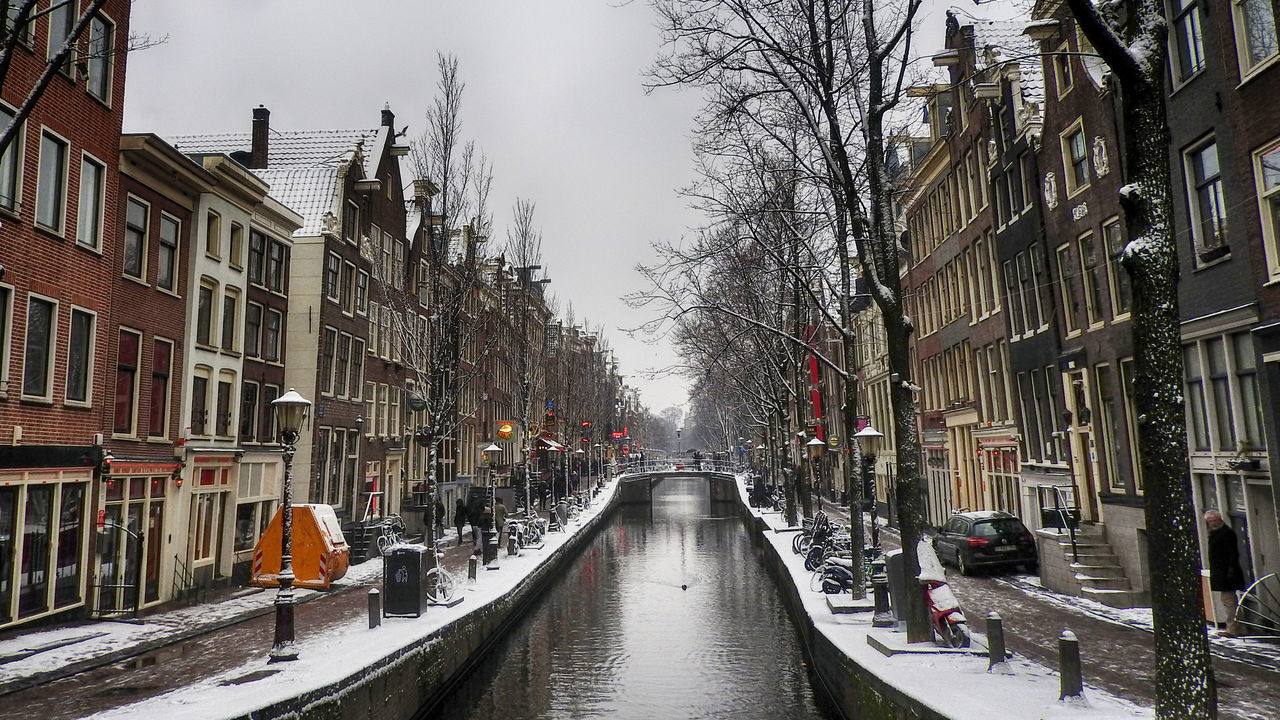 architecture, built structure, transportation, building exterior, mode of transport, tree, canal, city, sky, water, outdoors, day, no people, nautical vessel