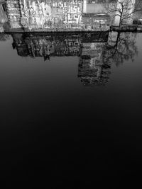 Reflection of tree in water against sky