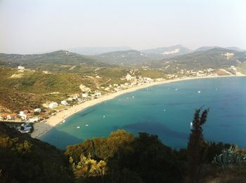 Scenic view of sea and mountains against sky