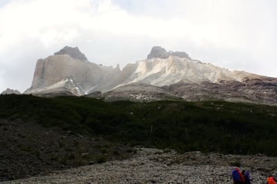 Scenic view of mountains against cloudy sky