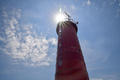 Low angle view of lighthouse against sky on sunny day