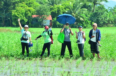 Group of people standing on grassland