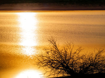 Scenic view of lake against sky during sunset