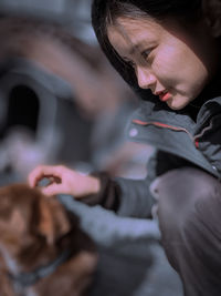 A woman is playing with her dog