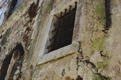 Low angle view of weathered wall of old building