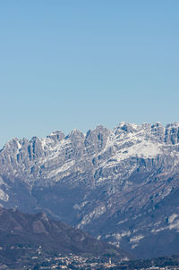 Scenic view of snowcapped mountains against clear blue sky