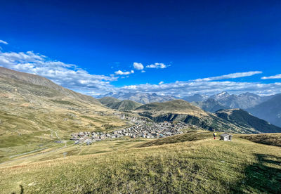 Scenic view of mountains against blue sky
