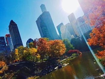 Low angle view of skyscrapers against blue sky