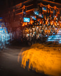 Digital composite image of illuminated city street and buildings at night