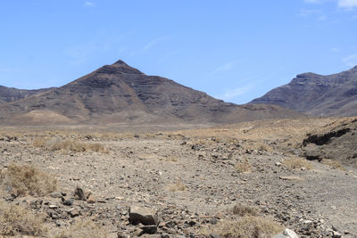 Scenic view of arid landscape against sky