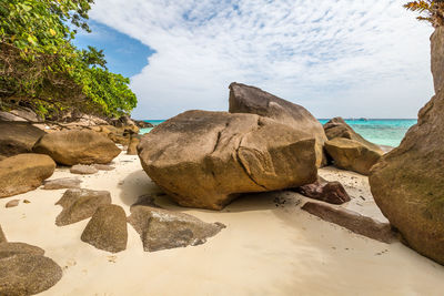 Rocks on beach against sky