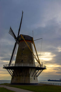 Traditional windmill against sky